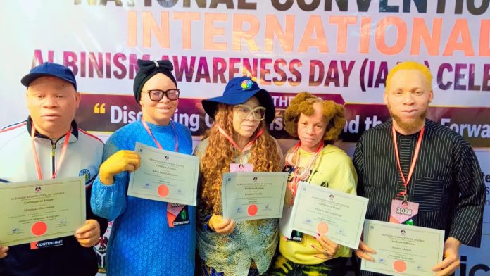 L-R: Abimbola Oluwatosin Oluwasegun, Assistant Secretary; ; Isola Omotola Elizabeth, Treasurer; Josephine Omolola, National President; Ademeko Busayo, Welfare Officer; and Ibrahim Momoh, Financial Secretary; with their certificates as newly elected executives of the Albinism Association of Nigeria (AAN).