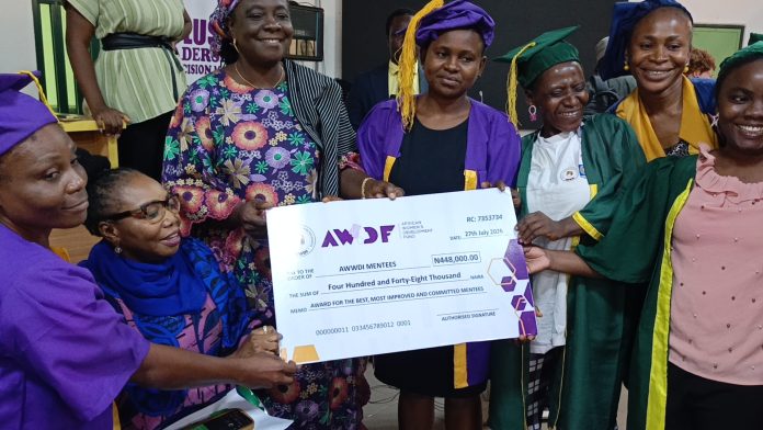 The ED, AWWDI, Patience Ogolo Dickson and some dignitaries presenting Cash Reward to Some Graduates